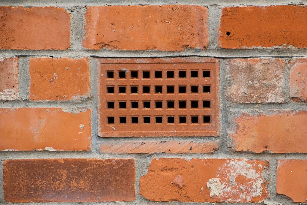 Air brick. brick wall with a close up showing a ventilation brick
