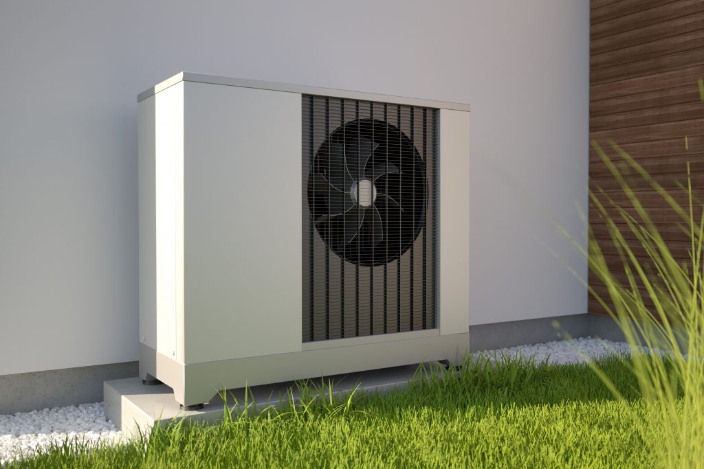 an air source heat pump outside in a garden on a sunny day