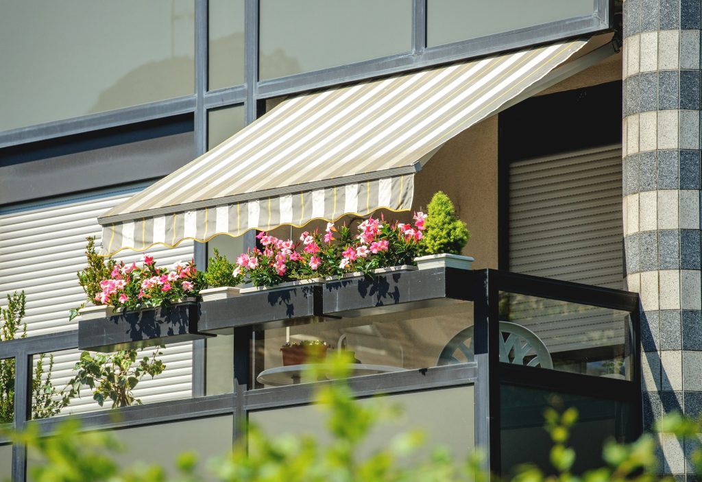 awnings over a window as external shading to avoid bedroom overheating in summer 