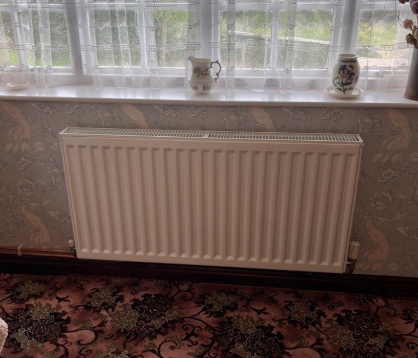 a newly installed radiator which is slightly taller than the other allowing the heat pump to run more efficiently