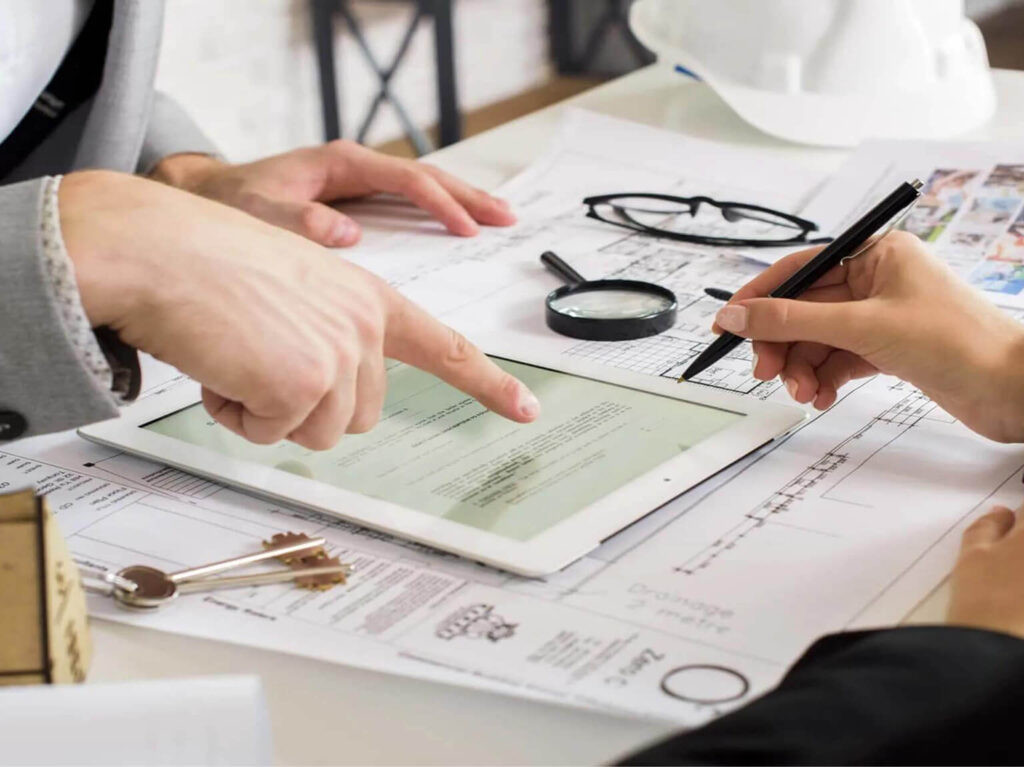 People reviewing property documents and planning maintenance tasks