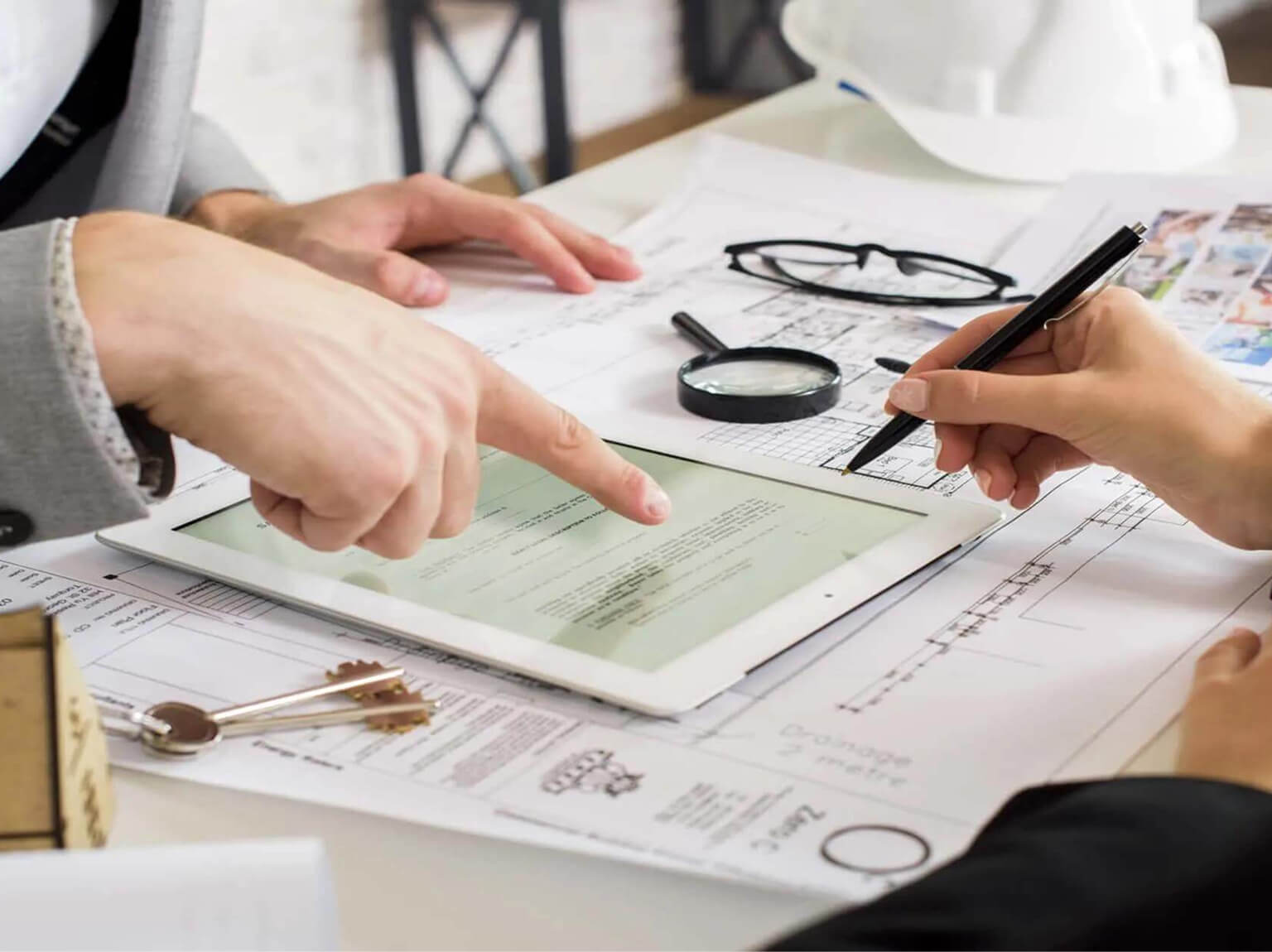 People reviewing property documents and planning maintenance tasks